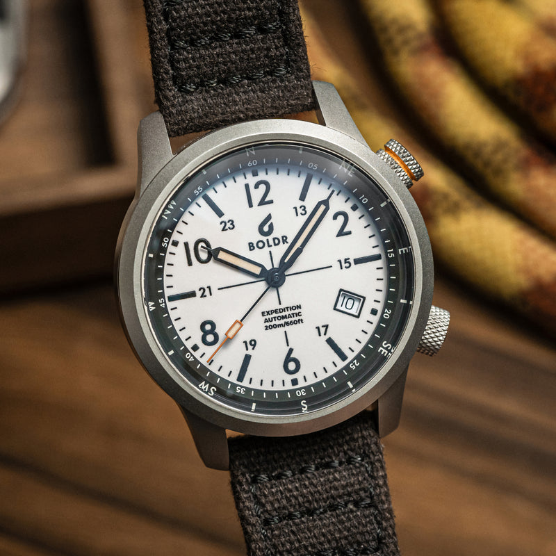 BOLDR Expedition White Sands watch with a white dial and compass bezel, showcasing its rugged design and functionality.