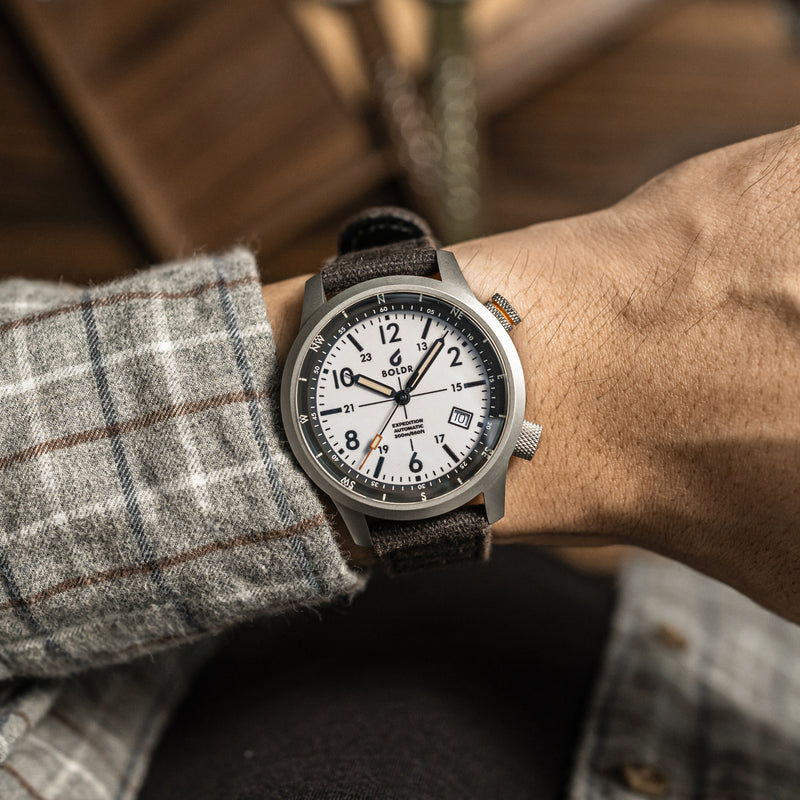 BOLDR Expedition White Sands watch with a white dial and compass bezel, showcasing its rugged design and functionality.