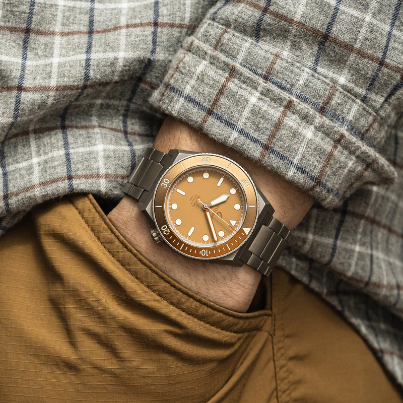 BOLDR Venture watch with a brown dial, luminous markers, and a stainless steel bracelet.
