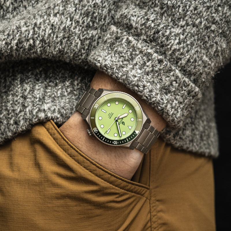BOLDR Venture watch with a light green dial, luminous markers, and a stainless steel bracelet. Pocket shot.