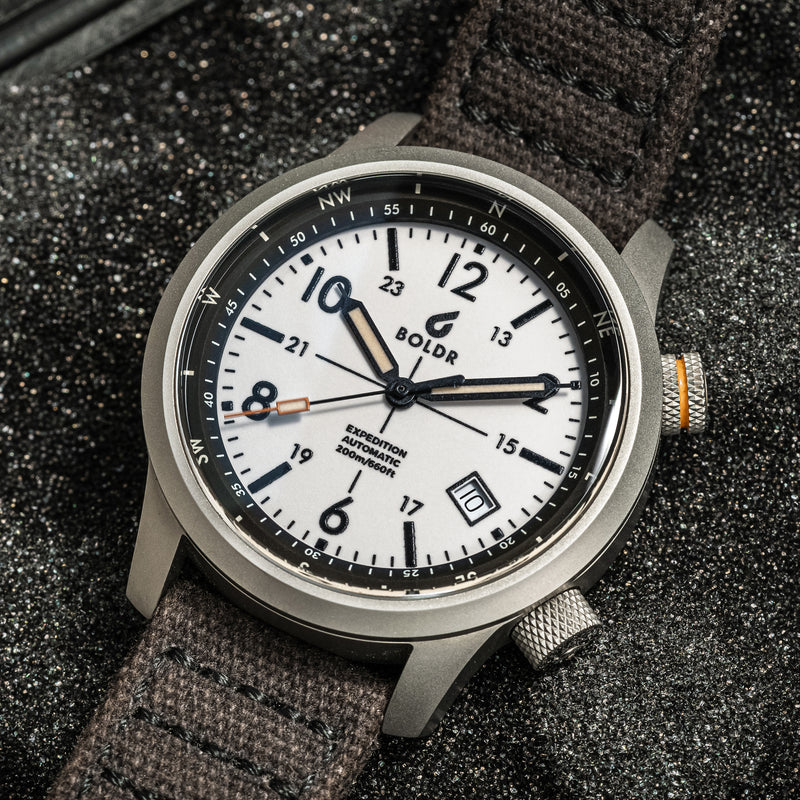 BOLDR Expedition White Sands watch with a white dial and compass bezel, showcasing its rugged design and functionality.