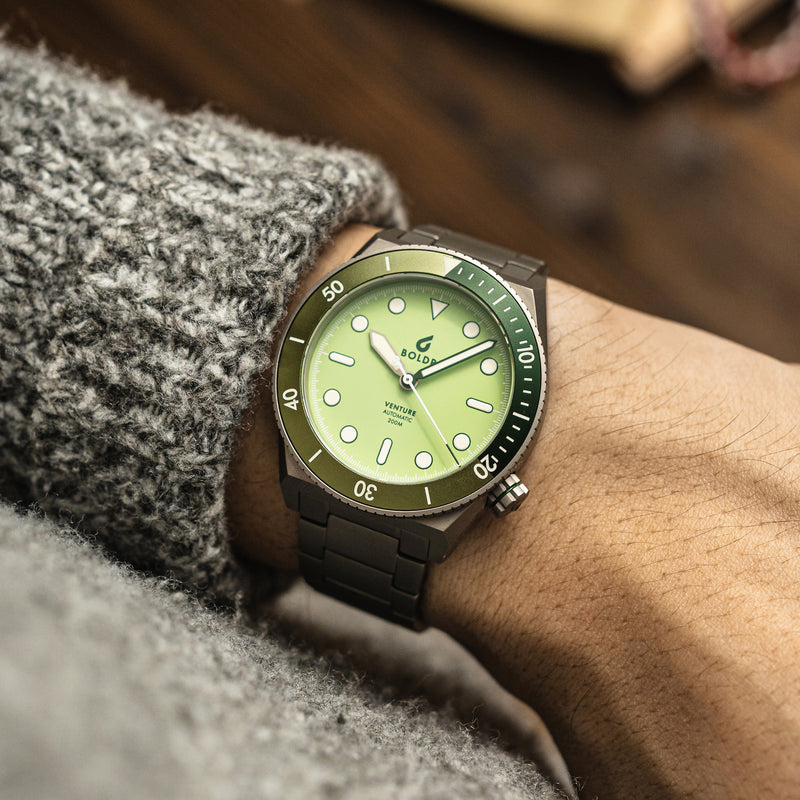 BOLDR Venture watch with a light green dial, luminous markers, and a stainless steel bracelet.