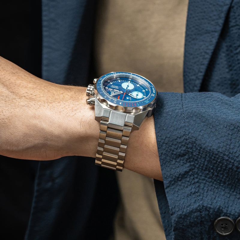 Close-up of a BOLDR Odyssey Regatta watch with a blue dial and stainless steel bracelet.