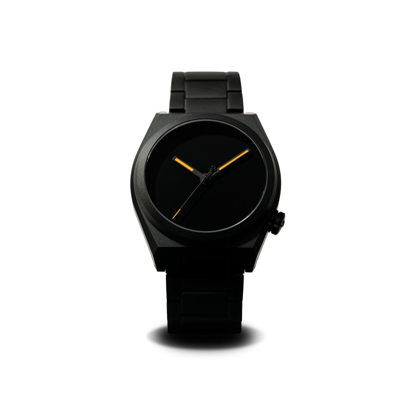 Front view of a black watch with a matte dial and minimalist design, showcasing its sleek and modern aesthetic